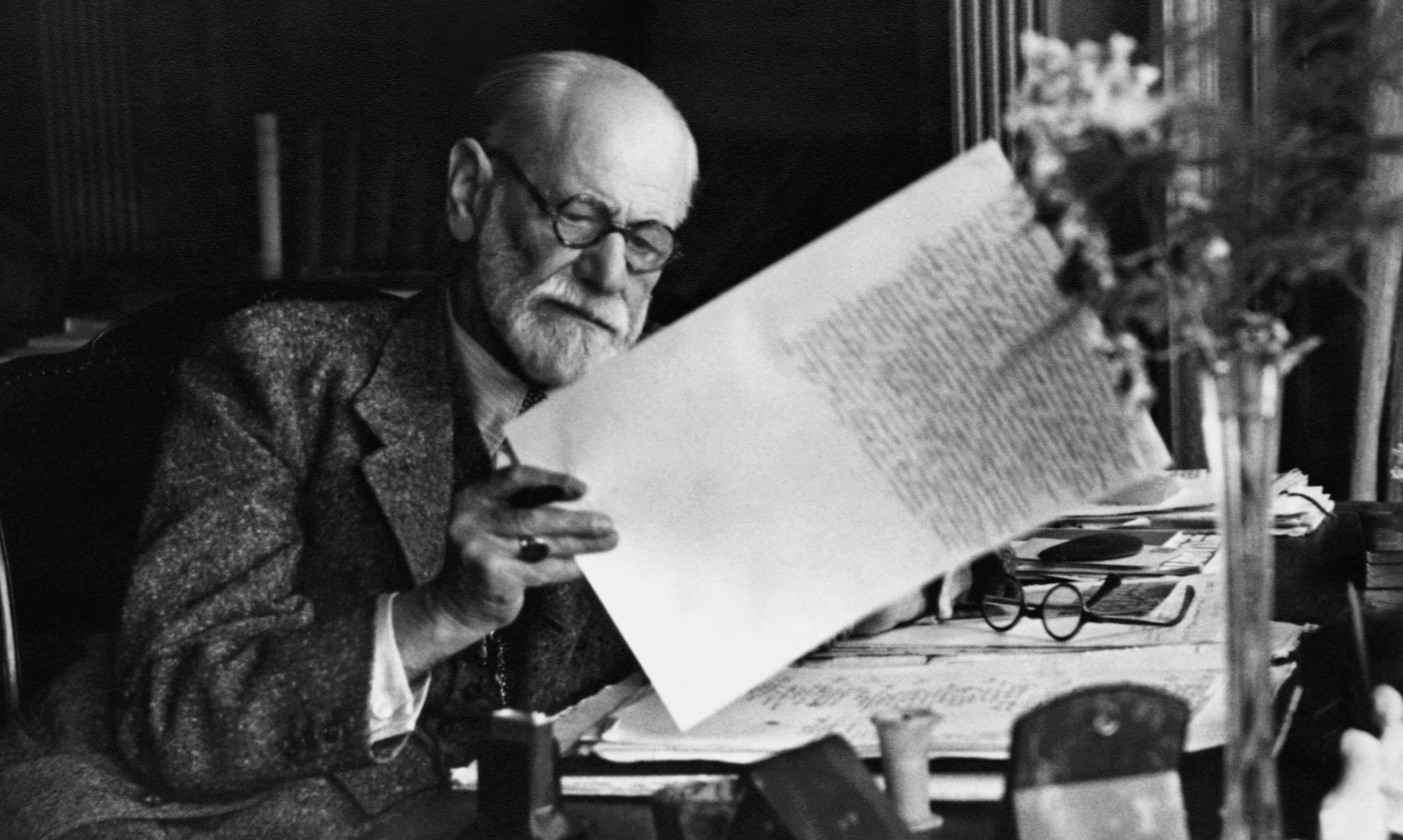 Original Caption: Sigmund Freud, 1856-1939, Austrian psychiatrist, in the office of his Vienna home looking at a manuscript. B/w photo ca.1930.